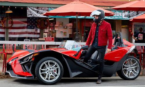 Red Polaris Slingshot rental parked outside a storefront in Blowing Rock, North Carolina